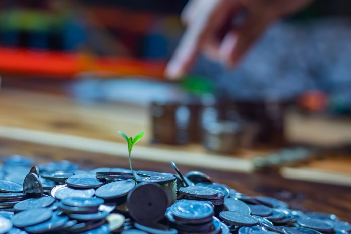 Many coins on a wooden table